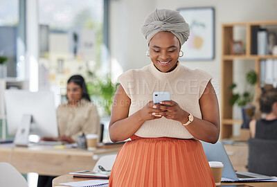 Buy stock photo Black business woman texting on a phone, smiling while standing in a busy corporate office. Small business owner happy, reading email and positive feedback. Female enjoying her career and success