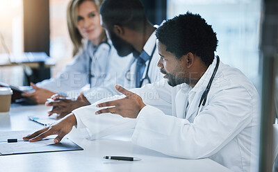 Buy stock photo Healthcare, diversity and a medical conference, male doctor in discussion or meeting with team. Teamwork, collaboration and communication, health care workers talking and planning at hospital office.
