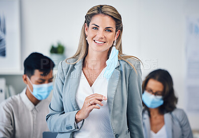 Buy stock photo Portrait of a business woman in her office with a face mask and her team during covid pandemic. Corporate, creative and professional manager working on a group project in the company conference room.
