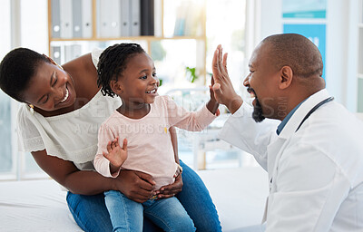 Buy stock photo Healthcare, mother and girl gives doctor high five in a doctors office. Medical insurance, healthy child development and consulting in a doctors office. Black woman, daughter and pediatrician smiling