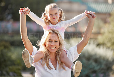 Buy stock photo Happy mother playing with daughter on her shoulders in their backyard on a sunny day. Energetic woman play and having fun with her girl. Family bonding and laughing together on the weekend