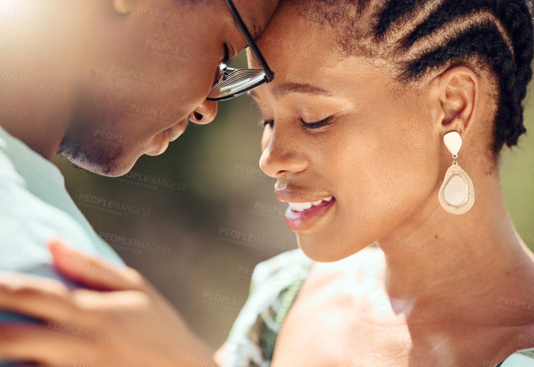 Buy stock photo Happy couple hugging in nature while on a romantic date while bonding in the park. Closeup of care, love and young man and woman embracing each other in an outdoor garden during spring.
