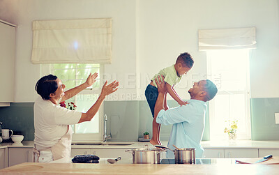 Buy stock photo Family, father and son in the kitchen with happy, playful and joy time at home smiling in happiness. Parents in care, love and fun with child together in a house playing with smile and funny moments.