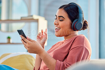 Buy stock photo Woman on couch, smartphone and headphones for music, audio and connectivity in lounge. Hispanic female, girl and headset for radio, podcast and streaming to listen, social media, connect or happiness