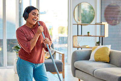 Buy stock photo Singing, cleaning and headphones of a woman with music working in a home dancing with happiness. Spring cleaning, cleaner and happy person sing and dance with a mop in living room listening to audio