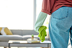 Woman, cleaning service and cloth to clean dirt, dust and bacteria in home living room for housekeeping, maintenance and disinfection. Hand of cleaner in jeans to work in apartment with gloves