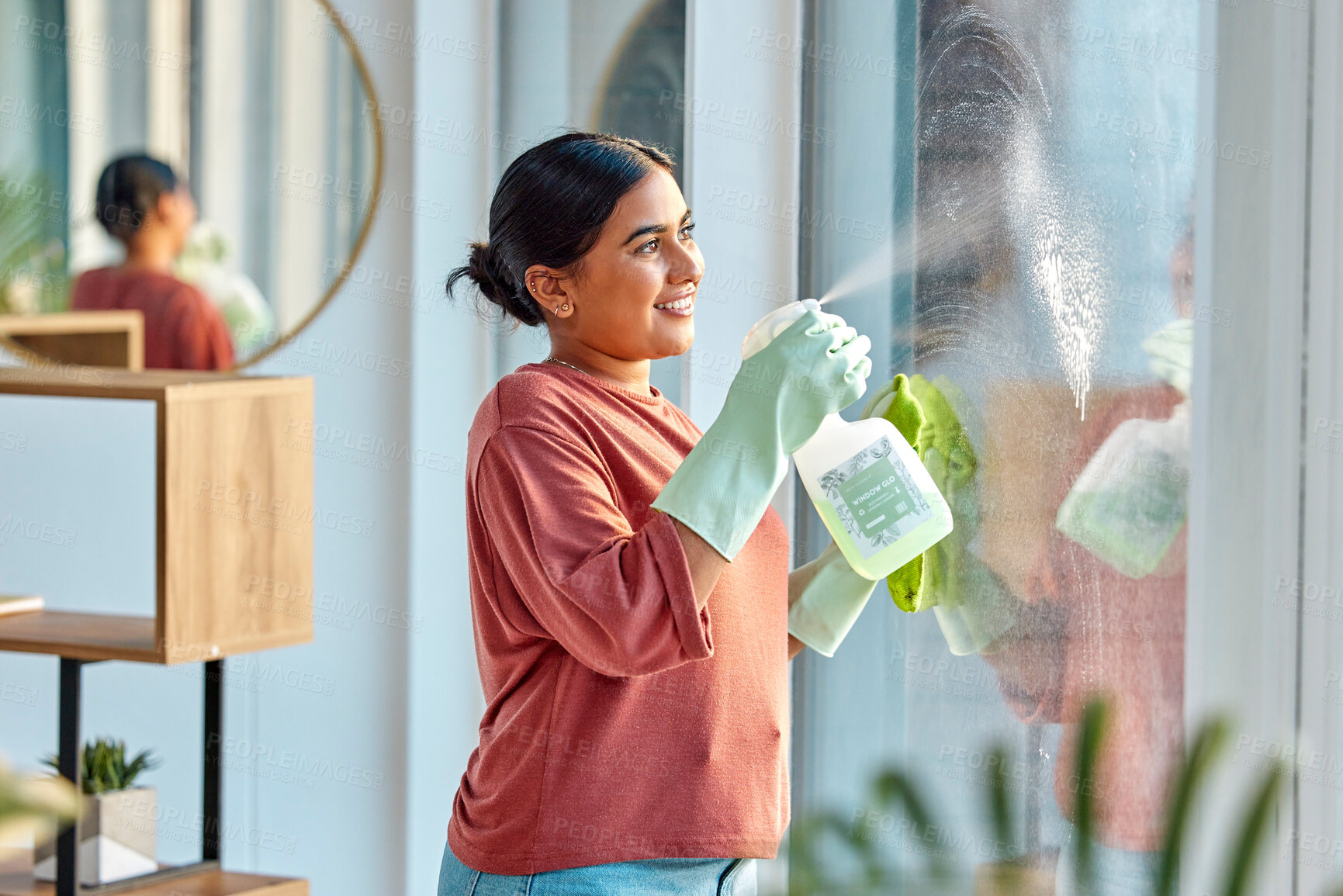 Buy stock photo Woman, cleaning and spray product of a cleaner washing a window with a smile in home. Happy working maid use a home hygiene bottle and cloth to disinfect the house furniture with a sanitizer bottle
