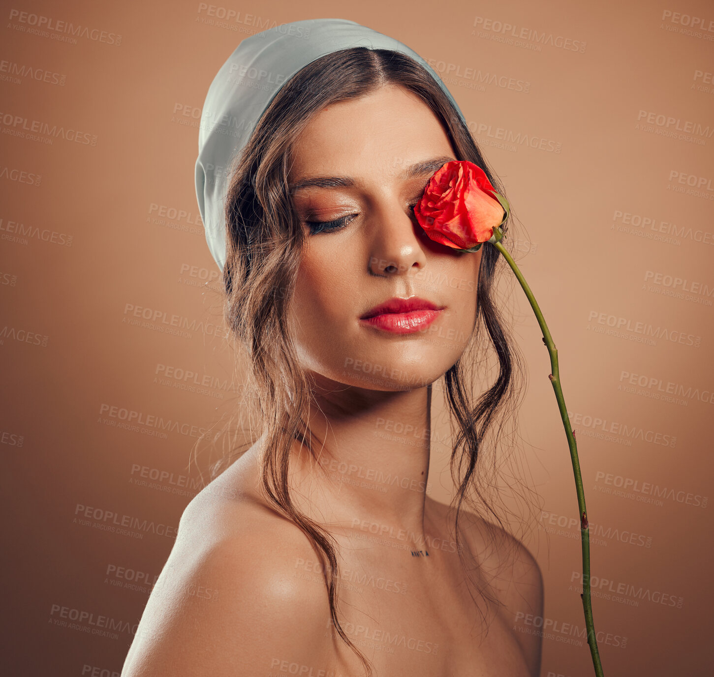 Buy stock photo Flowers, thinking and woman with makeup beauty, floral wellness and creative on a brown studio background. Peace, flower and model with a rose for creativity, luxury aesthetic and idea for cosmetics