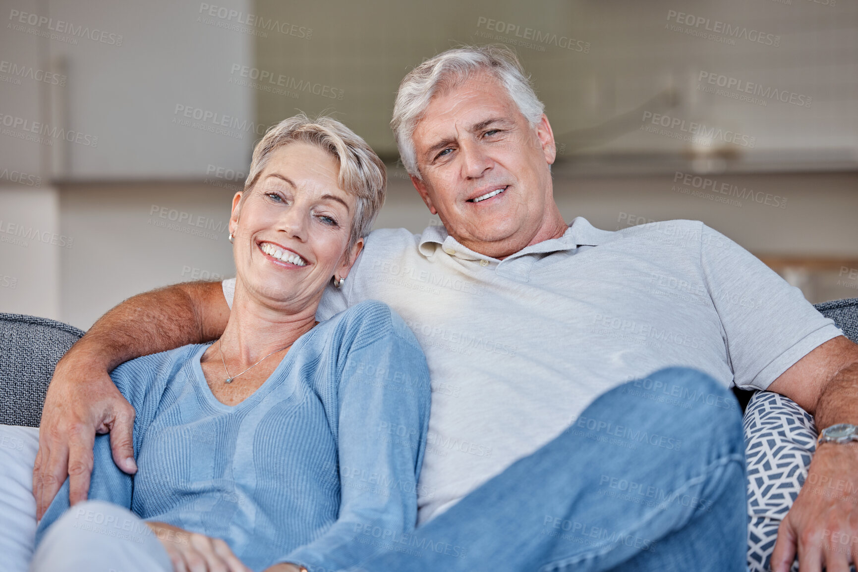 Buy stock photo Senior couple, sofa and portrait with smile, love and happy in retirement, bonding or care in family house. Old woman, elderly man and hug on couch for happiness, romance or embrace together at house