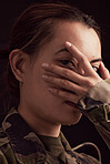 Soldier woman, mental health and hand on face in studio for depressed, anxiety or stress in war clothes. Military ptsd, trauma memory and army portrait by black background with depression in Ukraine