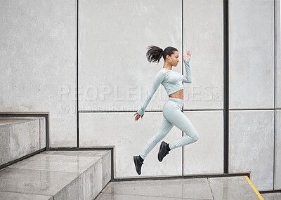Buy stock photo Running stairs and jump of a black woman doing training, sport and exercise with energy. Jumping, runner and morning fitness of woman doing sports, workout and cardio by steps for health and wellness
