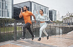 Running, couple and speed run partner in the rain for sports focus and urban workout. City sports, healthy exercise and black people in winter doing running runner training for road fitness for race 