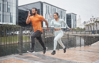 Buy stock photo Running, couple and speed run partner in the rain for sport focus and urban workout. City sports, healthy exercise and black people in winter doing wellness runner training for road fitness race 