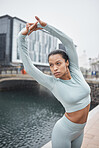 Fitness, exercise and woman stretching outdoor in city for workout and cardio training for health and wellness. Female athlete at urban water canal in London for muscle warm up and energy for running