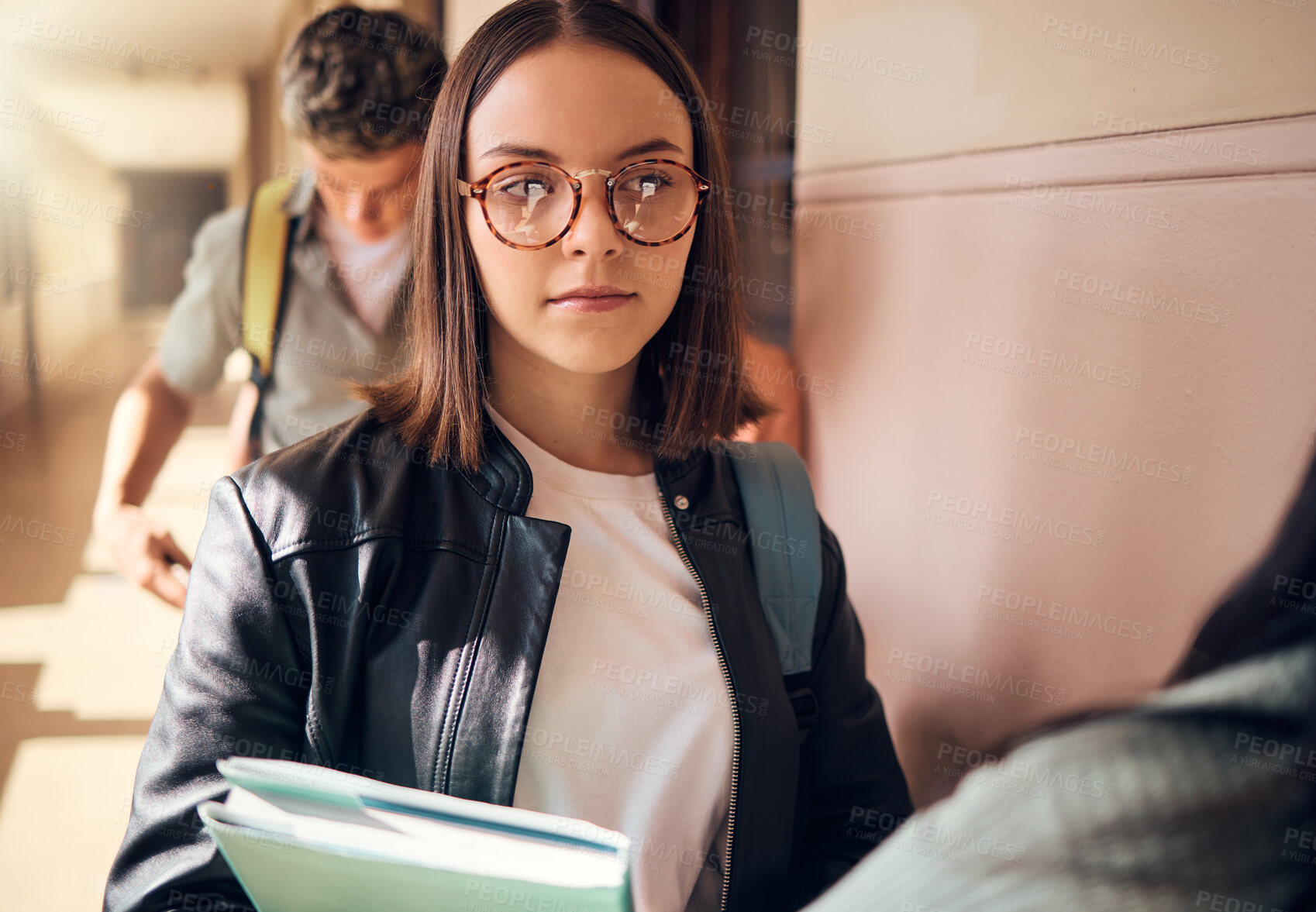 Buy stock photo University student, girl and talking to friends at campus corridor with books for learning, education and knowledge. Young  gen z female college student in building hallway at academy for studying 