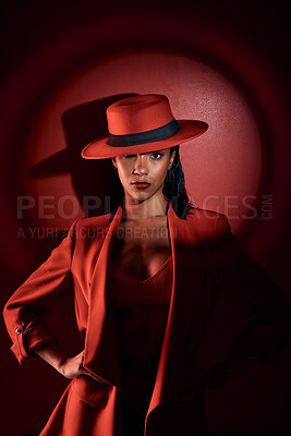 Buy stock photo Spotlight, red suit and woman with fashion from 90s, elegant clothes and vintage on a studio background. Creative, dark and portrait of a retro, confident and classy model with a sexy aesthetic