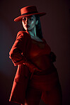 Fashion, red and edgy with a model black woman in studio on a dark background for trendy or contemporary style. Creative, hat and clothes with an attractive young female posing in stylish clothing