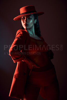 Buy stock photo Fashion, red and edgy with a model black woman in studio on a dark background for trendy or contemporary style. Creative, hat and clothes with an attractive young female posing in stylish clothing