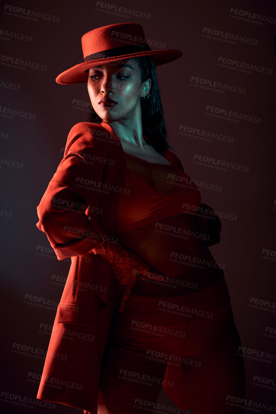 Buy stock photo Fashion, red and edgy with a model black woman in studio on a dark background for trendy or contemporary style. Creative, hat and clothes with an attractive young female posing in stylish clothing