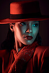 Dark, seductive and vintage woman thinking of fashion, red clothes and creative against a dark black studio background. Mysterious, elegant beauty and face of a model in the 90s with an idea