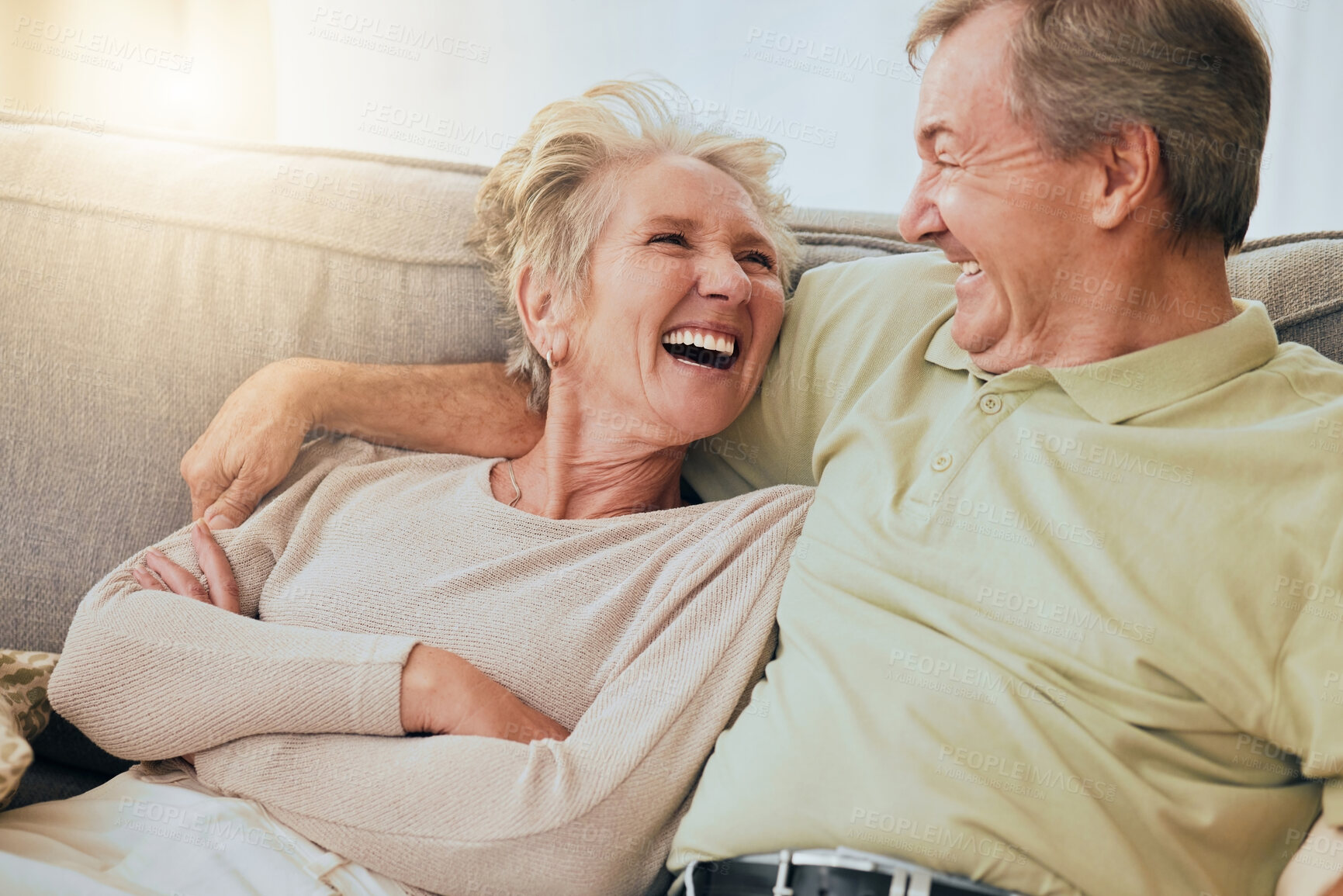 Buy stock photo Elderly couple, laugh and hug on sofa in happy relationship, silly face or bonding together at home. Senior couple laughing, humor or relaxing while making funny goofy faces on living room couch