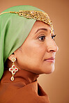 Face, beauty and fashion with a muslim woman in studio on a brown background for style or skincare. Luxury, wellness and makeup with an islamic female posing for her culture, heritage or tradition