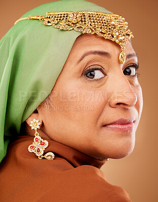 Buy stock photo Mature muslim woman, face or fashion hijab on studio background with traditional jewellery, religion jewelry or trendy accessory. Zoom, portrait or middle aged Islamic model in stylish hijab earrings