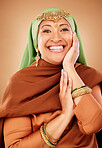 Portrait, face and skincare with a muslim woman in studio on a brown background for culture or tradition. Happy, smile and beauty with an islamic female posing to promote natural care or heritage