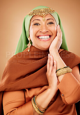 Buy stock photo Portrait, face and skincare with a muslim woman in studio on a brown background for culture or tradition. Happy, smile and beauty with an islamic female posing to promote natural care or heritage