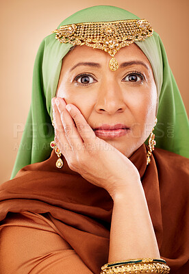 Buy stock photo Portrait, muslim and beauty with a model woman in studio on a beige background for skincare or tradition. Face, fashion and culture with an attractive maturre islamic female proud of her heritage
