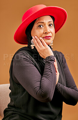 Buy stock photo Fashion, stylish and senior Muslim woman with beauty, elegant clothes and vintage on a brown studio background. Designer clothing, classy and face portrait of an elderly model with fancy elegance