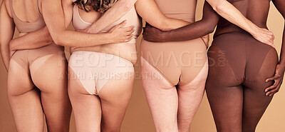 Buy stock photo Self love, diversity and women underwear group for skin color inclusivity panties campaign back view. Body positive, plus size and interracial people hug together on beige studio background.

