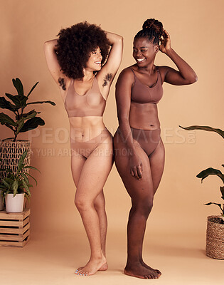 Buy stock photo Diversity, body and natural with black woman friends in studio on a beige background for beauty or equality. Health, wellness and armpit hair with a model female and friend posing in underwear