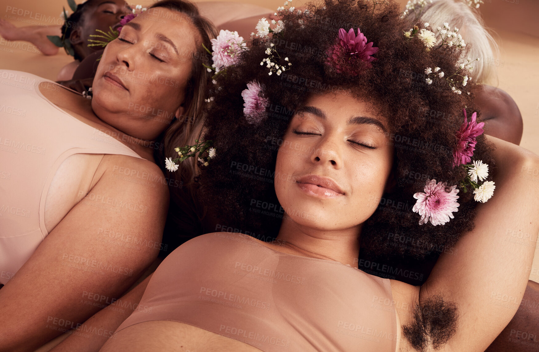 Buy stock photo Flowers, sleep and face of women in studio relaxing for peace, beauty or zen. Floral makeup, organic cosmetics and diversity of body positive group of friends in underwear sleeping together on floor.