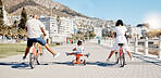 Black family, bike and children with a girl and parents having fun together on the promenade in summer. Freedom, bicycle and kids with a mother, father and daughter riding while bonding from the back