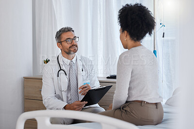 Buy stock photo Doctor, patient and hospital consultation while talking about healthcare, health insurance and results with checklist for examination and therapy. Man and woman together for wellness and counseling