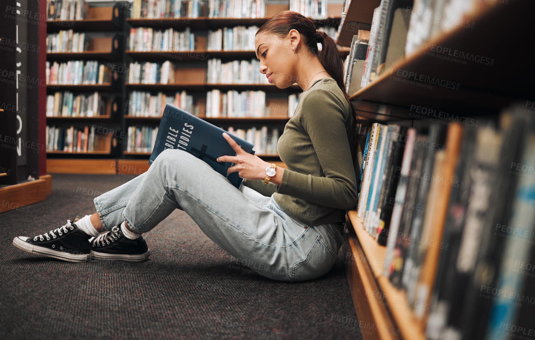 Buy stock photo Book, reading and library student on floor with learning, education and research for school, university or college with inspiration. Bookshelf, Bible study history and a woman on ground reading book