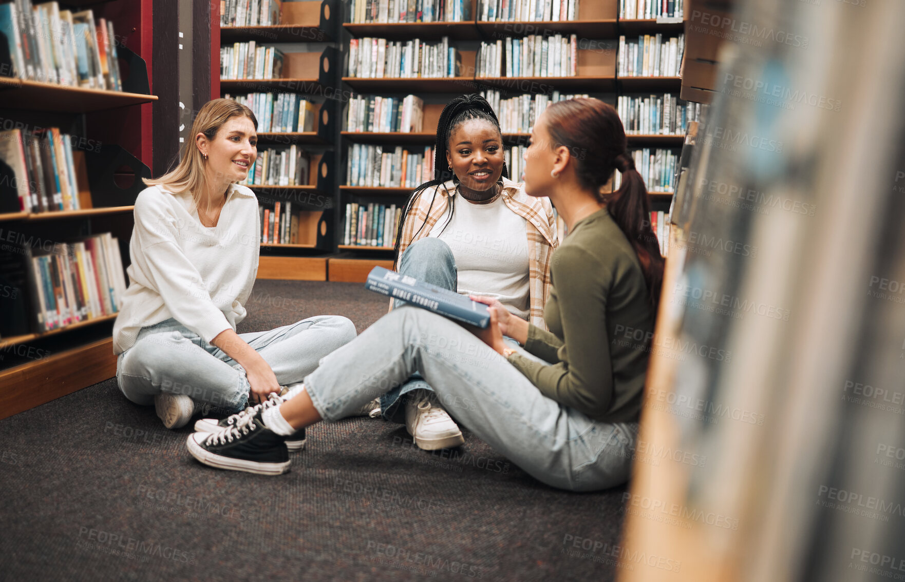 Buy stock photo Library, book and group of women reading for education, research and knowledge at university. Discussion, scholarship and female students studying for a test, exam or assignment together at college.