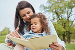 Mother, girl book and reading in park for storytelling, development and relax for bonding together. Mom, female child and learning with story, education or love in garden, nature or backyard in Miami