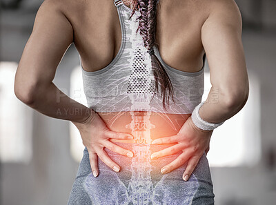Buy stock photo Closeup of one caucasian woman holding her sore lower back while exercising in a gym. Female athlete suffering with painful spine injury from fractured joint and inflamed muscles during workout. Struggling with stiff body cramps causing discomfort