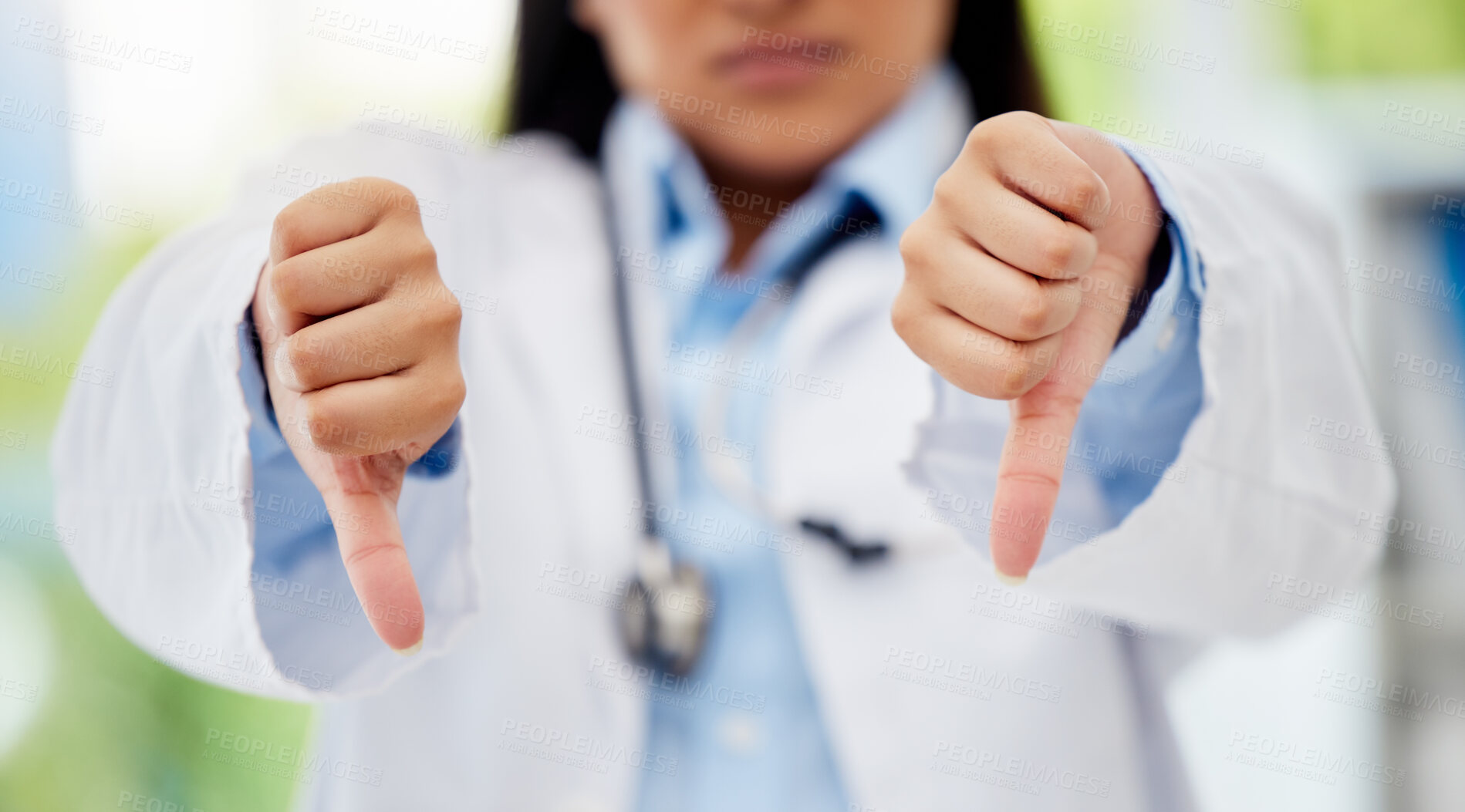 Buy stock photo Doctor with thumbs down hand sign in healthcare hospital or lab for fail, poor health insurance or death statistics. Zoom of unhappy, bad loss or loser hands emoji icon of a healthcare professional