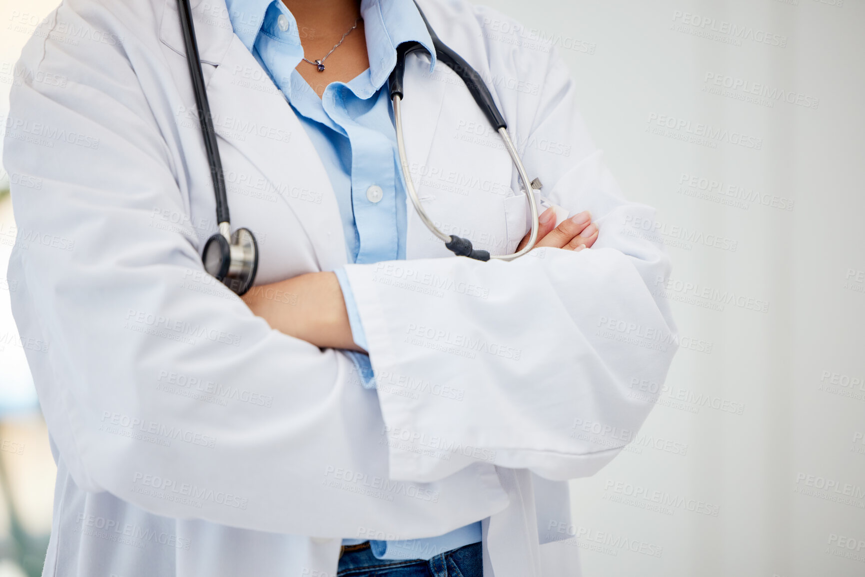 Buy stock photo Medical healthcare doctor, woman worker or employee arms crossed standing confident with stethoscope in hospital. Leadership, work and wellness female staff manager nurse working in medicine office.