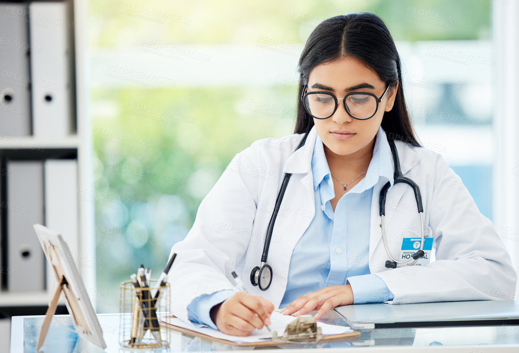 Buy stock photo Doctor, insurance and medical of a woman filling out patient history for diagnosis at the hospital. Healthcare worker or nurse writing on paper with clipboard for health and wellness at the office.