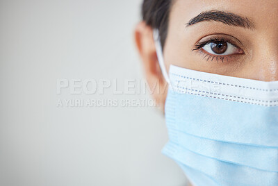 Buy stock photo Health, wellness and covid safety mask of a young woman face and head. Eye zoom of a female with nose and mouth cover for prevention and protection from corona virus, flu and cold in a pandemic