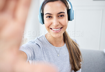 Buy stock photo Portrait of happy woman take selfie and smile with headphones while listening to music in the living room. Young beautiful lady streaming a podcast at home and relax in lounge and express happiness