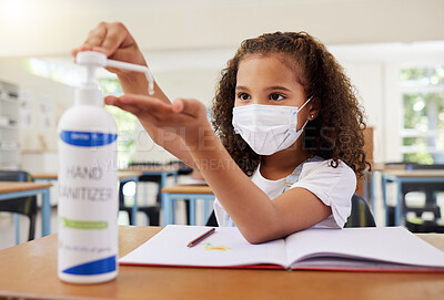 Buy stock photo Sanitizer, covid and clean young girl at elementary school wearing a mask in a classroom. A child following protective covid19 regulations by cleaning her hands to prevent infection