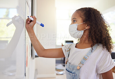 Buy stock photo Smart, clever and intelligent girl writing an answer on a whiteboard at elementary school during the covid pandemic. Child development or quality education for a young kid learning in class