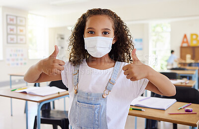 Buy stock photo Thumbs up for education with covid, school student pleased with learning wearing a mask and showing support in a classroom at school. Portrait of a little girl protecting from virus during pandemic