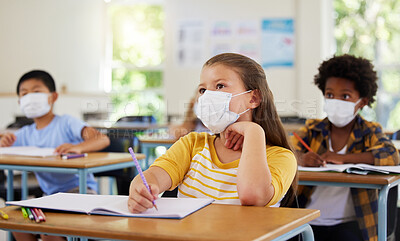 Buy stock photo Focused young girl in school after covid pandemic, sitting and listening in classroom while taking notes. Small child looking at board, learning and thinking for her education with other students