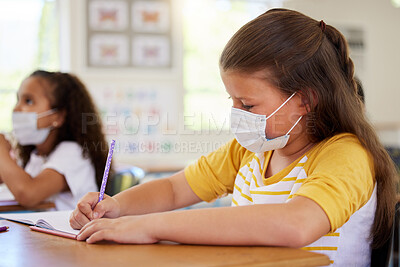 Buy stock photo School girls in classroom, covid education lockdown and social distance. Smart students creative drawing and writing at desks learning, wearing masks due to coronavirus disease regulations.